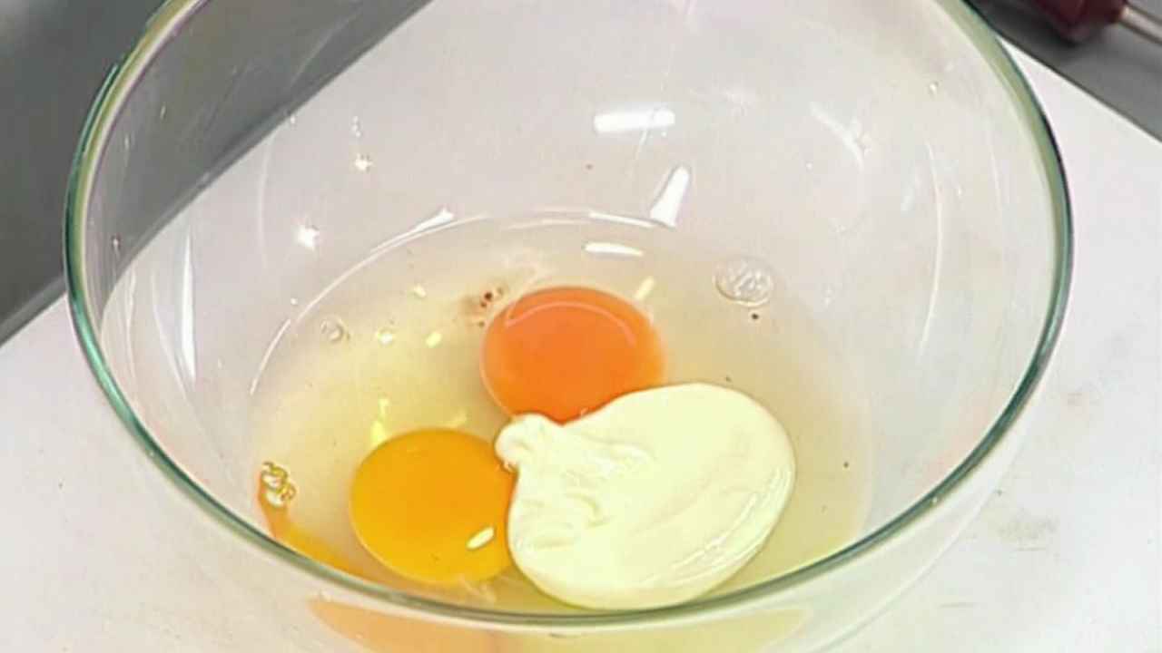 В миску разбить куриные яйца, добавить майонез.
